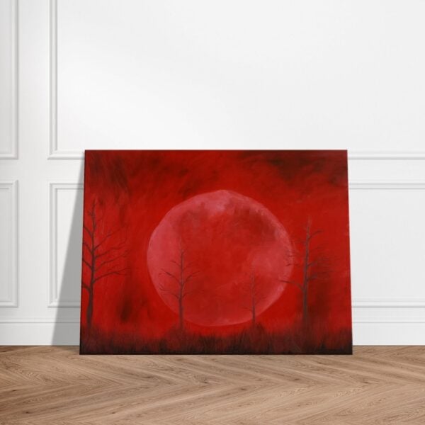Original oil painting of a red moon with dead trees, called Crimson Moon. The painting is standing on a wooden floor while leaning against a white wall.