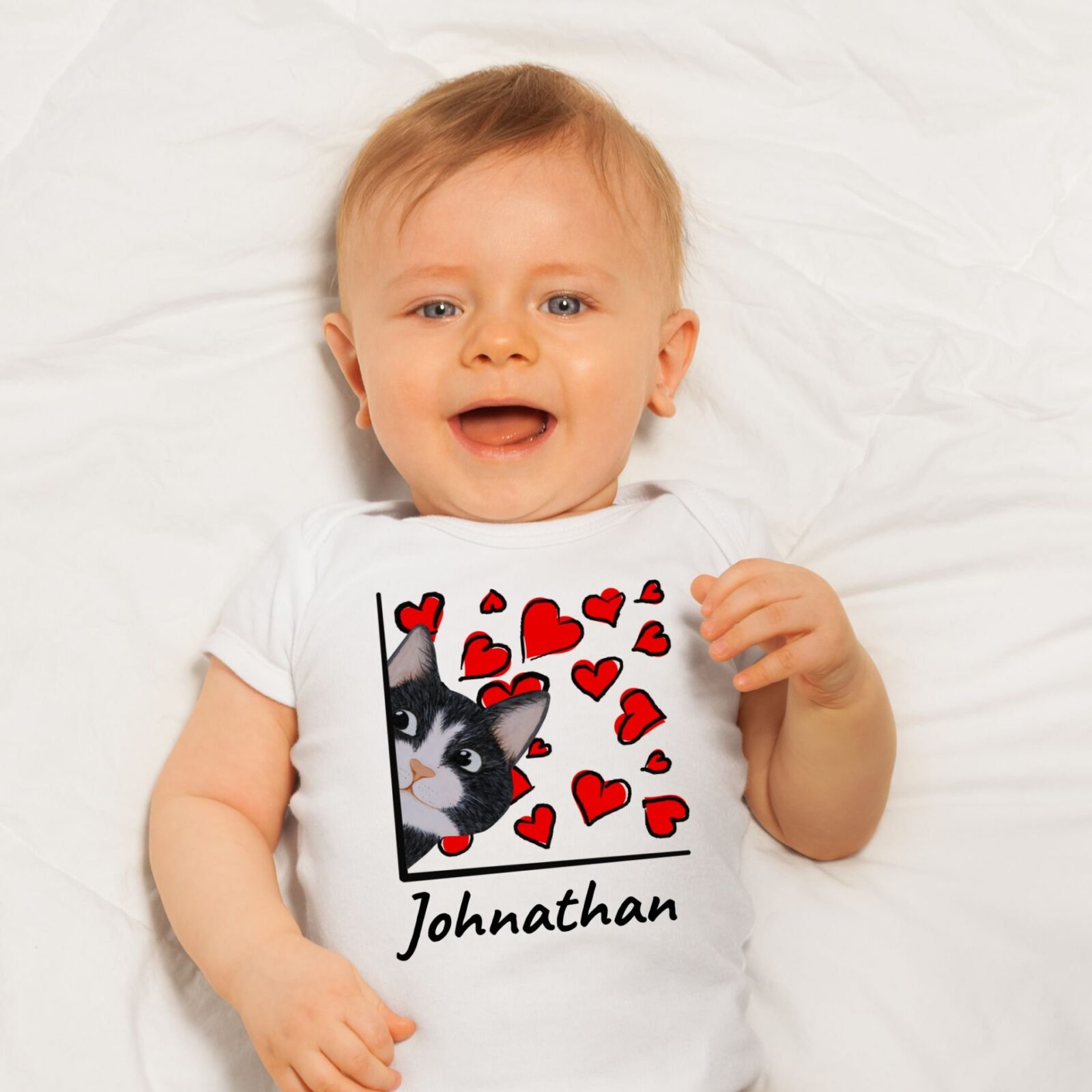 Baby wearing a white summer bodysuit with a black tuxedo cat design and the name "Johnathan" which is optional to personalize with your baby's name.