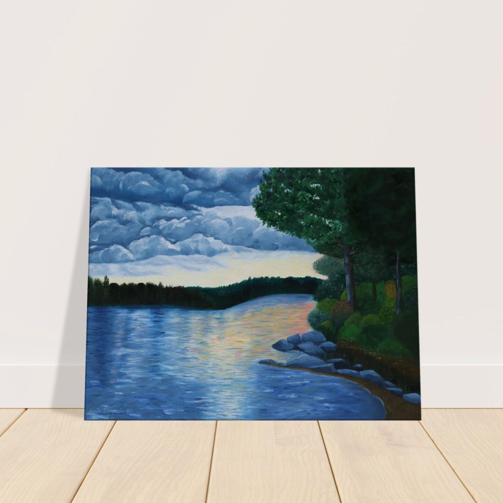 Sunset lake landscape canvas print standing on a wooden floor and resting against a wall.