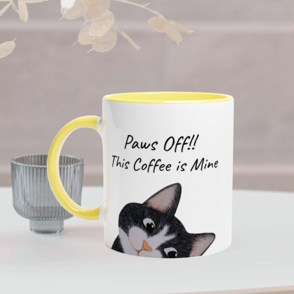 This white mug has a yellow handel and inside. It has a black cat design and text on the front sides of the mug. It is optional to personalize only the text on the mug.