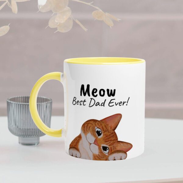 This white mug has a yellow handel and inside. It has a ginger cat design and text on both sides of the mug. It is optional to personalize the text.
