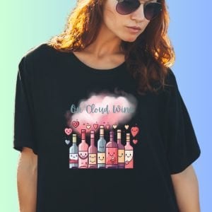 A woman wearing a black t-shirt with the text "On Cloud Wine" with colourful wine bottles, hearts and a pink cloud design.