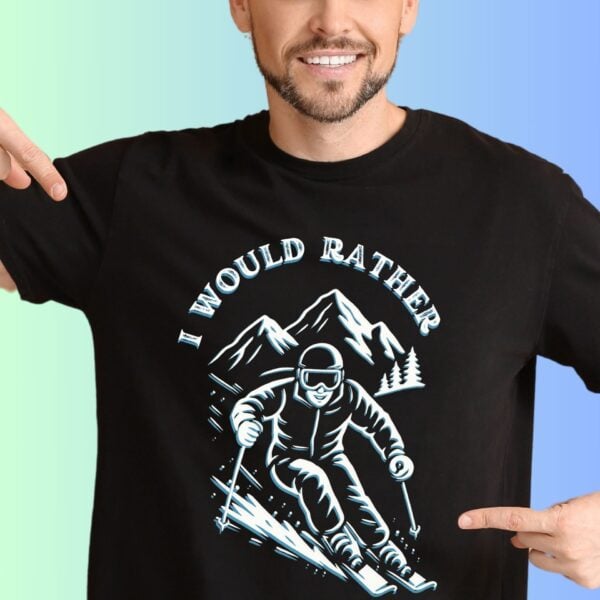 A man wearing a black t-shirt with the text "I would rather" with a person skiing against the backdrop of a mountain.