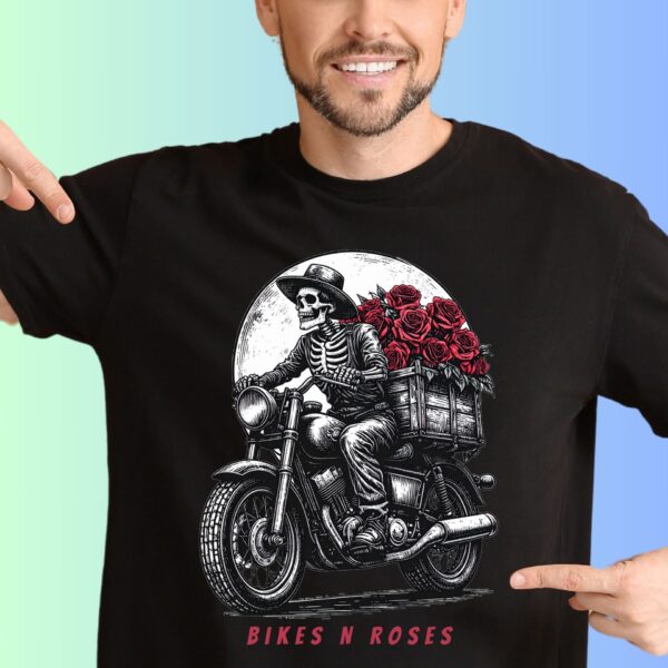 A man wearing a black gothic skeleton t-shirt featuring a skeleton on a weathered motorcycle,red roses and the text "Bikes n Roses". The text can be personalized.