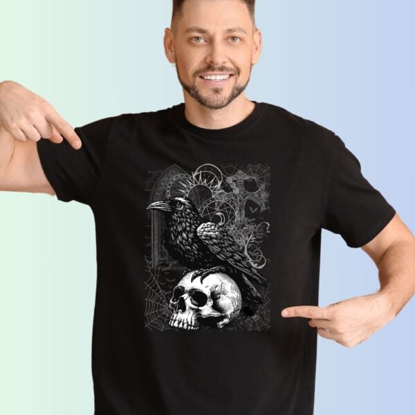 A man wearing a black t-shirt with a Gothic design. The design includes a crow, skull, spiders, bats and other Gothic elements. There are 13 colour options for the t-shirt: black, dark grey heather, navy, columbia blue, light blue, deep teal, forest, dark olive, maroon, heather raspberry, soft cream, pink and white.