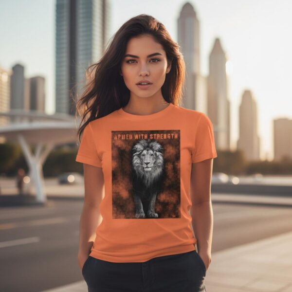 Armed in Strength Tshirt Orange Woman City A woman wearing an orange Unisex t-shirt with a Lion design. This Christian design includes the word "Armed with Strength".