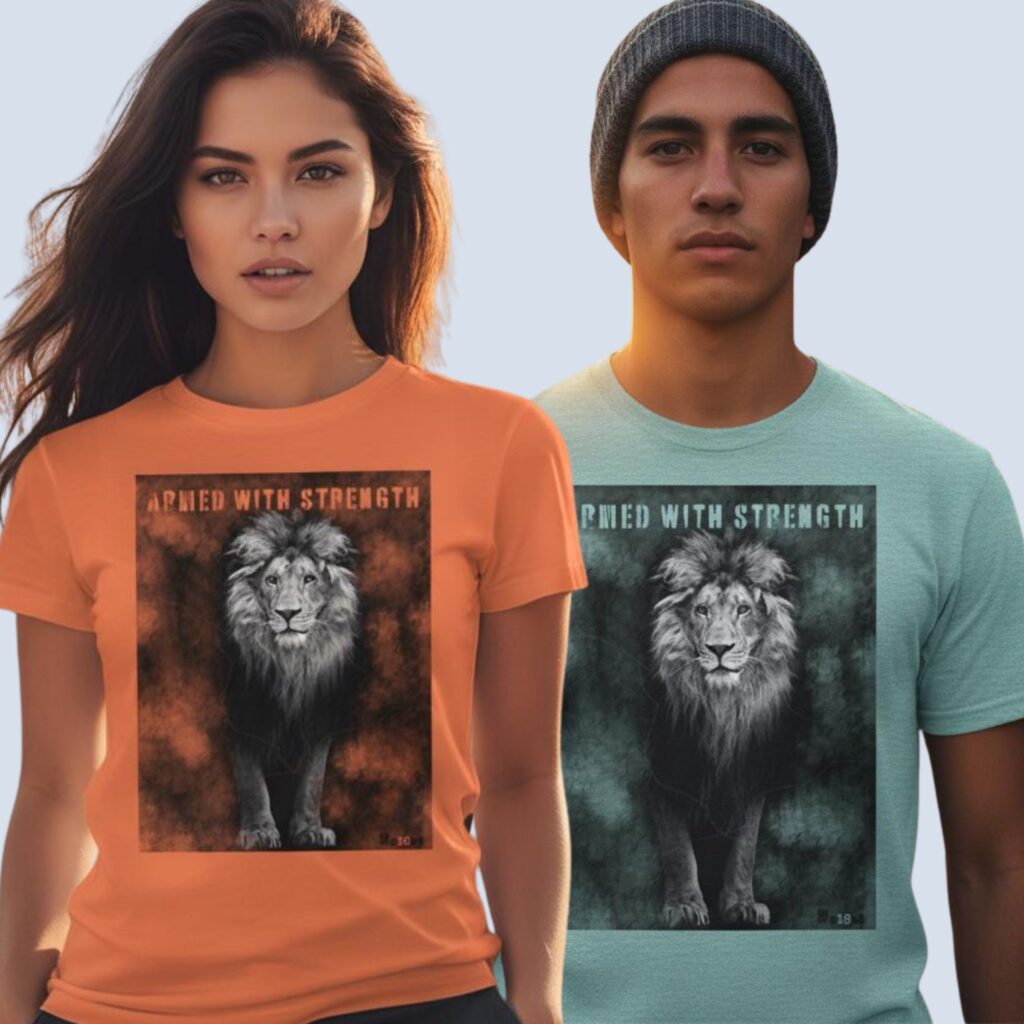 A woman wearing an orange unisex t-shirt and a man wearing a heather ice blue unisex t-shirt, both with a Lion design. This Christian design includes the word "Armed with Strength".