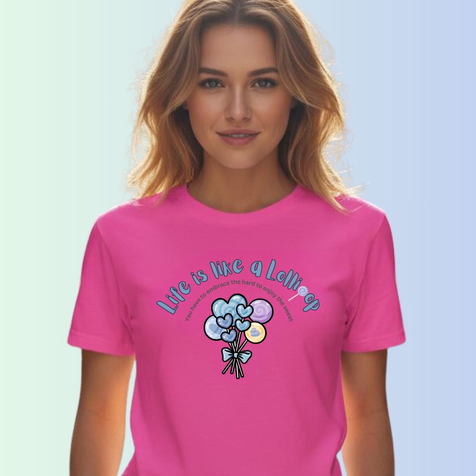 A woman wearing a charity pink coloured t-shirt with a lollipop design, the text "Life is like a Lollipop" and "you have to embrace the hard to enjoy the sweet".