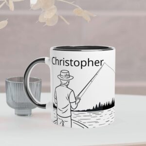 This white mug has a black coloured handle and inside. It has a fisherman design and custom text to personalize it with a person's name on the front of the mug, and on the back it has the text "I'd rather be fishing" which cannot be personalized.