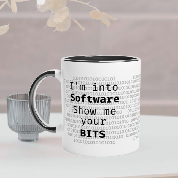 This white mug has a black coloured handle and inside. It has a IT design and text "I'm into software, show me your bits" on both sides of the mug.