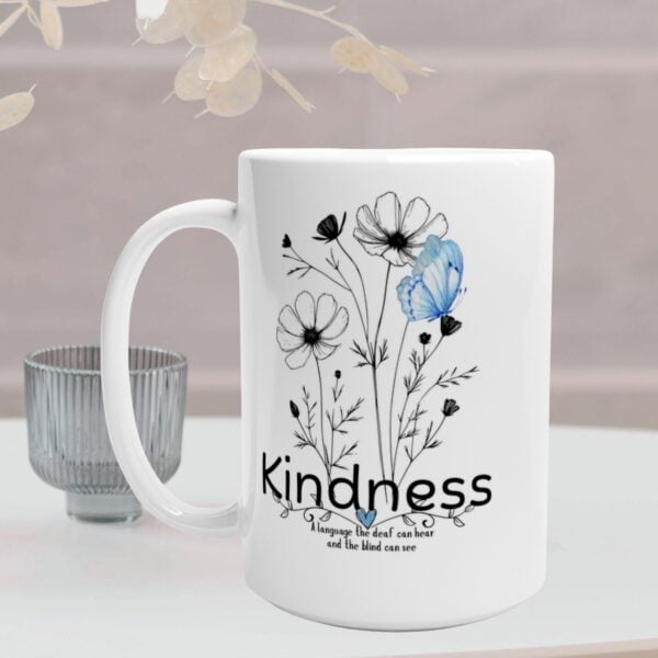 This white 15oz ceramic mug features a delicate line-art bouquet with a blue butterfly and the word “Kindness” — followed by the touching quote, “a language the deaf can hear and the blind can see.”