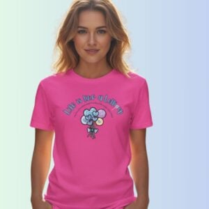 A woman wearing a charity pink coloured t-shirt with a lollipop design, the text "Life is like a Lollipop" and "you have to embrace the hard to enjoy the sweet".
