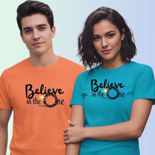 A man wearing a coral unisex t-shirt and a woman wearing an aqua unisex t-shirt, both with a religious design and the text "Believe in the One" relating to John 6:29.