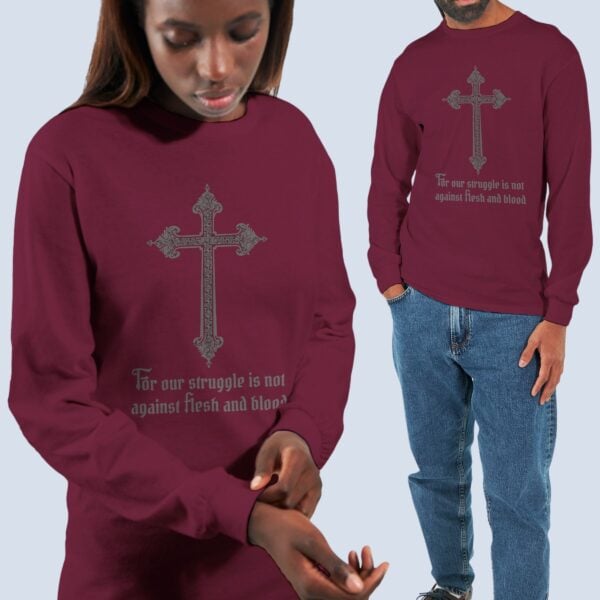 A Man and a woman wearing the cross design unisex long sleeve t-shirt with the text "For our struggle is not against flesh and blood"
