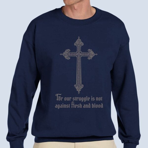 A Man wearing the cross design unisex sweatshirt with the text "For our struggle is not against flesh and blood".