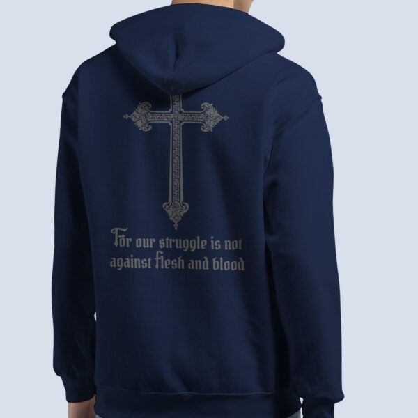 A man wearing a navy unisex zipper hoodie with a cross design and the text "For our struggle is not against flesh and blood" on the back of the hoodie.