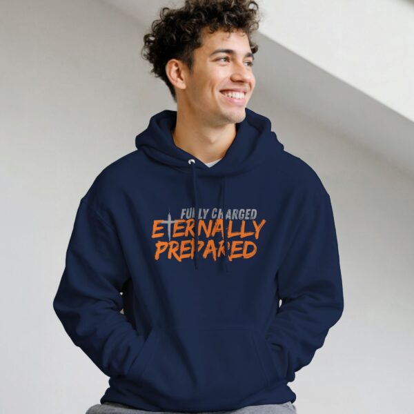 A man wearing a navy unisex pullover hoodie with a cross and the text "Fully Charged, Eternally Prepared".