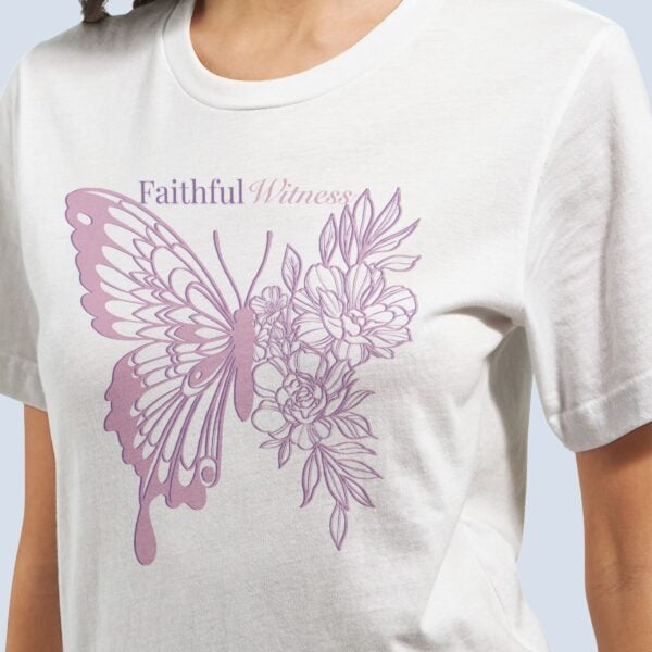 A woman wearing a white t-shirt with a butterfly and flower design and the text "Faithful Witness".