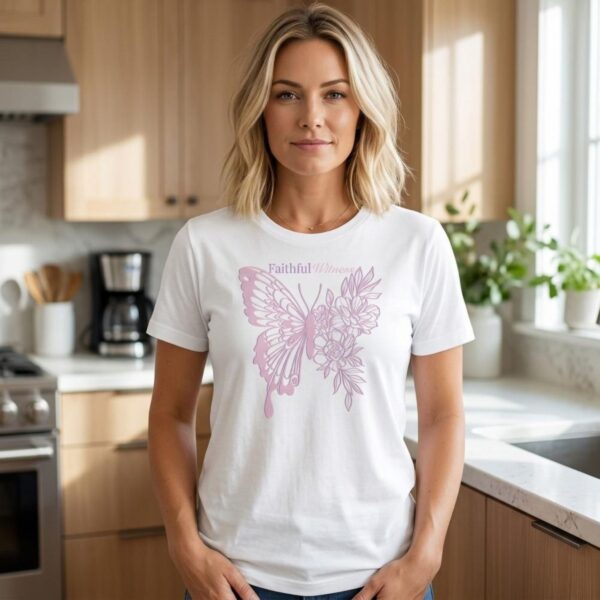A woman wearing a white t-shirt with a butterfly and flower design and the text "Faithful Witness".