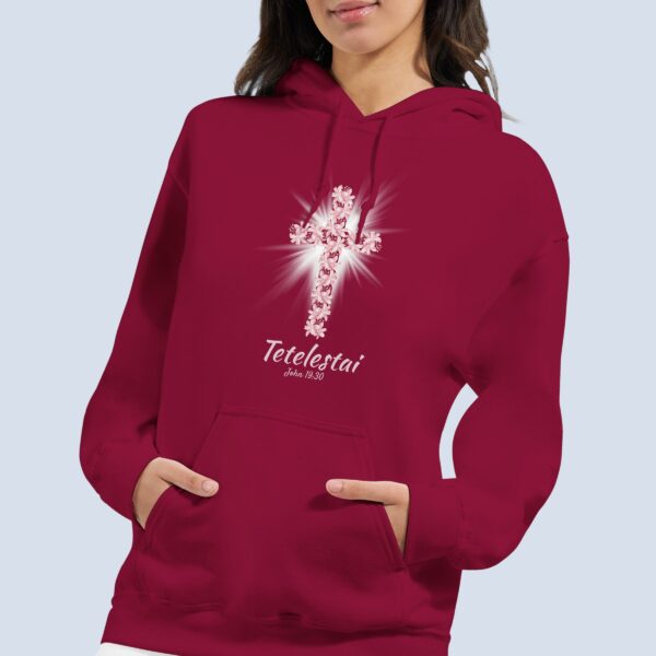 A woman wearing a Cardinal red pullover hoodie with a lily cross design and the text "Tetelestai, John 19:30".