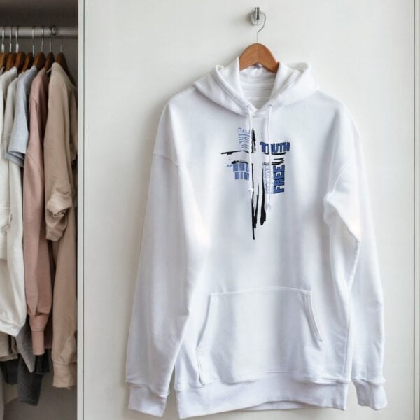 White Truth Cross unisex pullover hoodie hanging on the cupboard door.