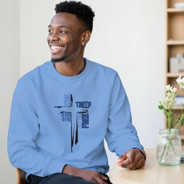 A man wearing a Carolina blue unisex sweatshirt with a cross design and the text "The Truth may tick you off, but it Will Set You Free".