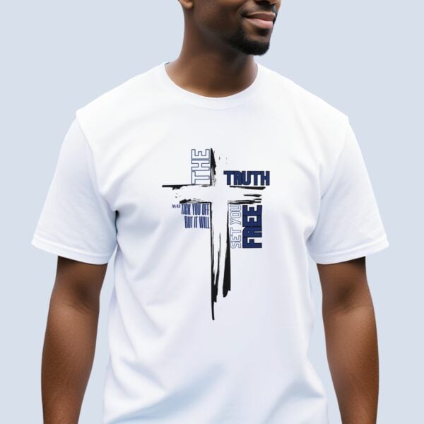 A man wearing a white t-shirt with a cross design and the text "The truth may tick you off but it will set you free".