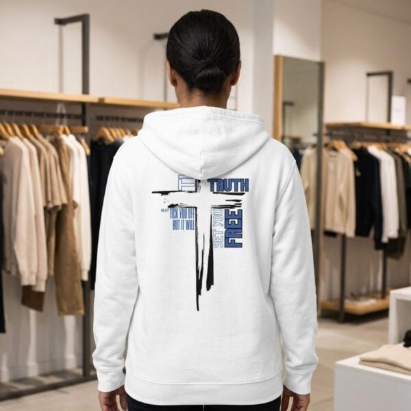 Truth Cross Zip Hoodie Woman store A woman wearing a white unisex zipper hoodie with a cross design and the text "The Truth may tick you off, but it Will Set You Free" on the back.