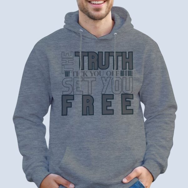 A man wearing a sport grey unisex pullover hoodie with the text "The Truth may tick you off, but it Will Set You Free".