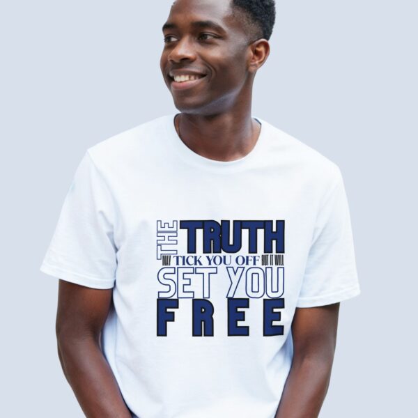 A man wearing a white unisex t-shirt with the text "The Truth may tick you off, but it Will Set You Free".