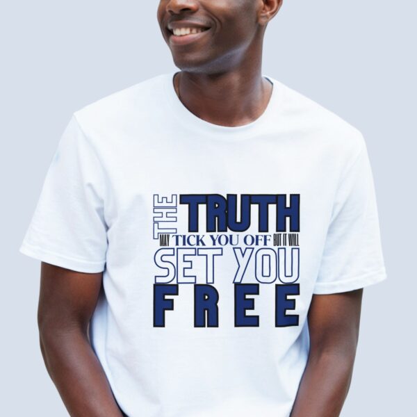 A man wearing a white unisex t-shirt with the text "The Truth may tick you off, but it Will Set You Free".
