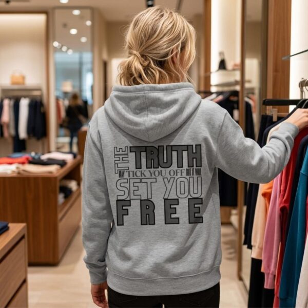 Truth Zip Hoodie Woman store A man wearing a white unisex zipper hoodie with a the text "The Truth may tick you off, but it Will Set You Free" on the back.