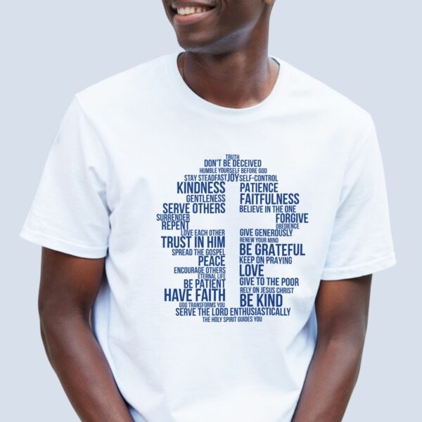A man wearing a white unisex t-shirt with a cross design surrounded by inspirational Christian phrases such as be kind, surrender, trust in Him, and give to the poor. The design is printed on the front of the t-shirt only.