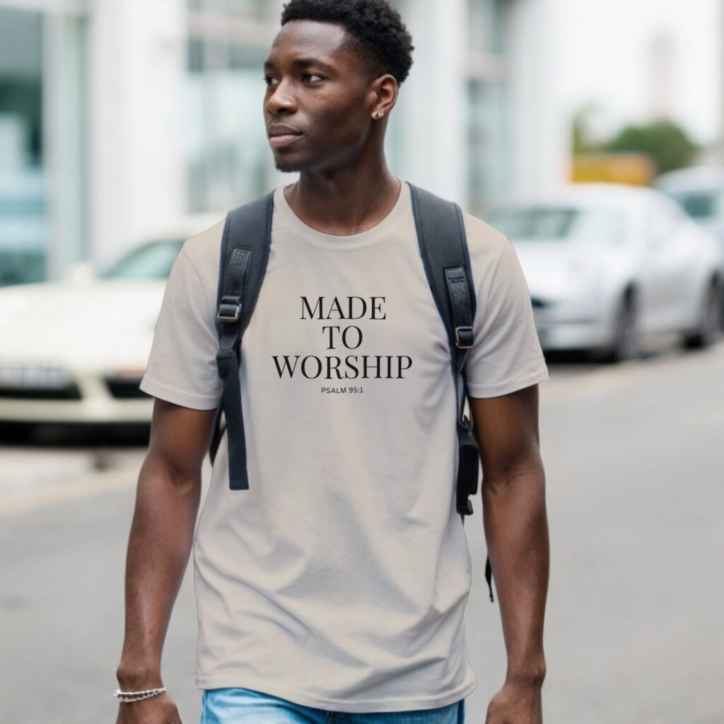 A man wearing a sand coloured unisex Christian t-shirt featuring the powerful words “Made to Worship” and "Psalm 95:1", printed on the front of the t-shirt. It is a soft faith-based tee with inspirational design perfect for church, gifts, and everyday wear.