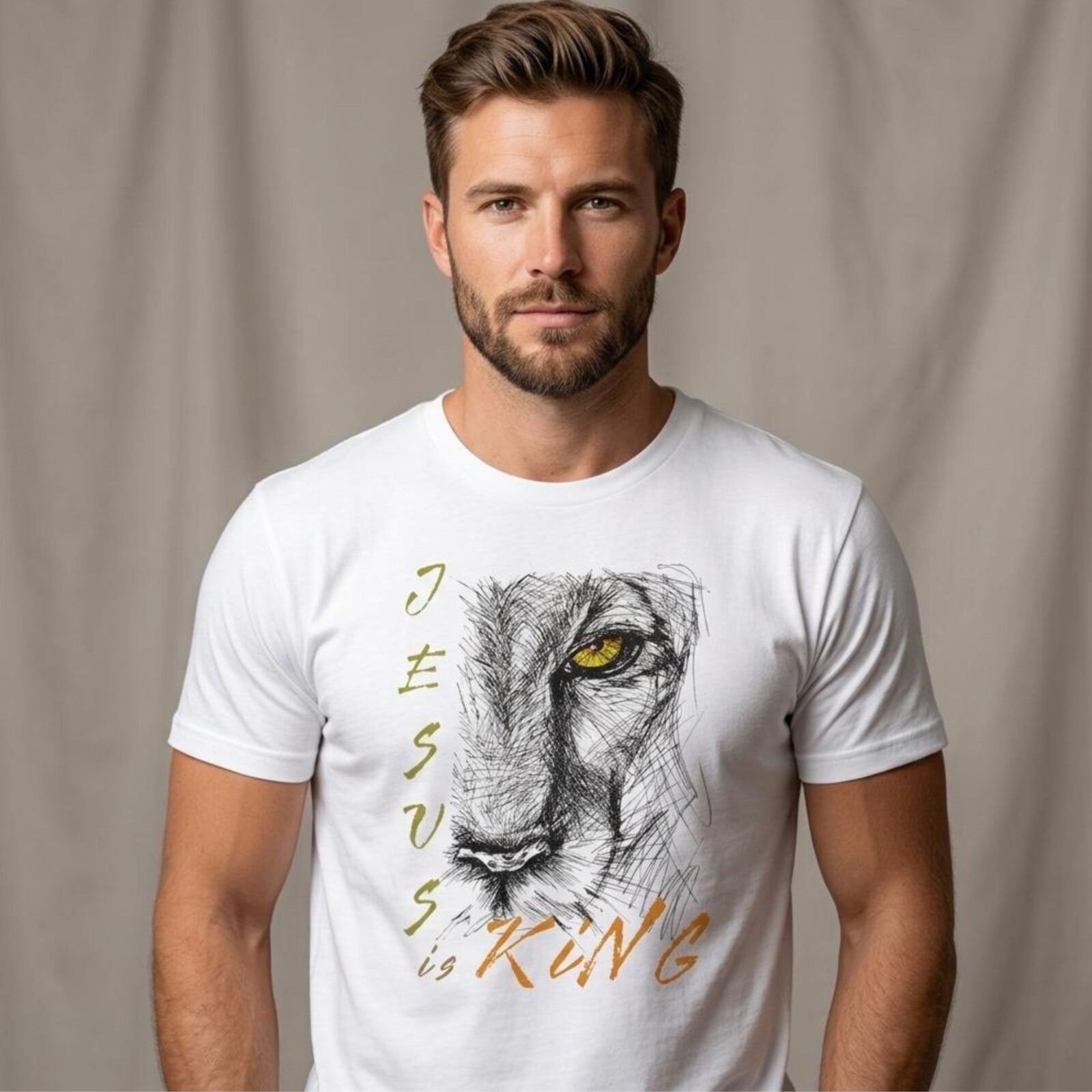 A man wearing a white Christian unisex t-shirt featuring a modern lion illustration, paired with the text: "Jesus Is King", inspired by Revelation 19:16.